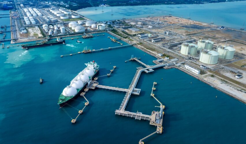 Energy Estimating - LNG (Liquified Natural Gas) tanker anchored in Gas terminal gas tanks for storage. Oil Crude Gas